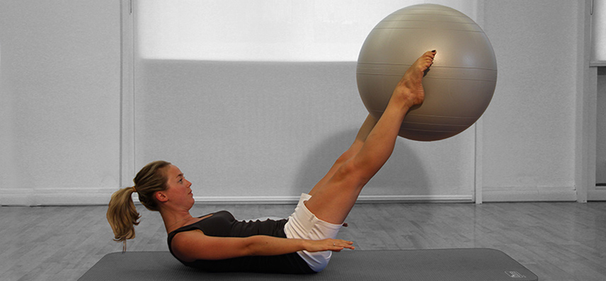 young teacher with exercise ball